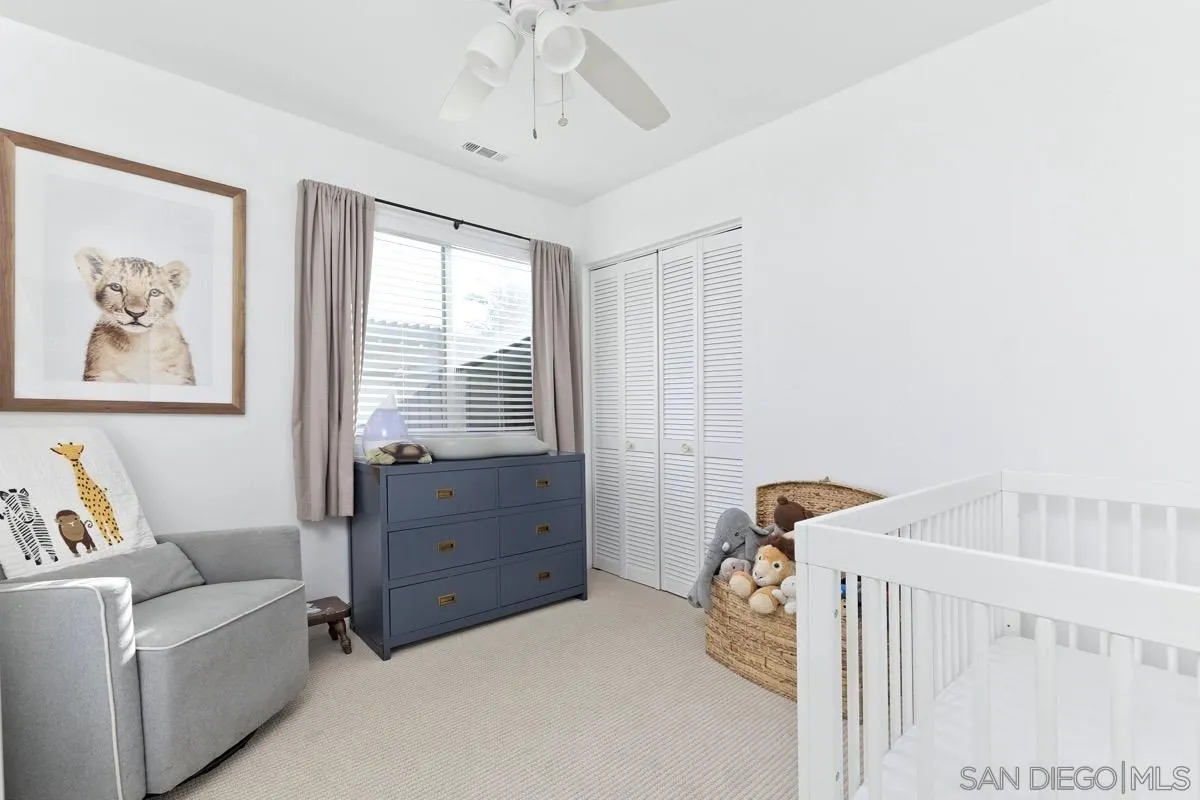1448 Third Street Coronado, CA 92118 - Photo 16 of 30 a bedroom with a baby bed and a window