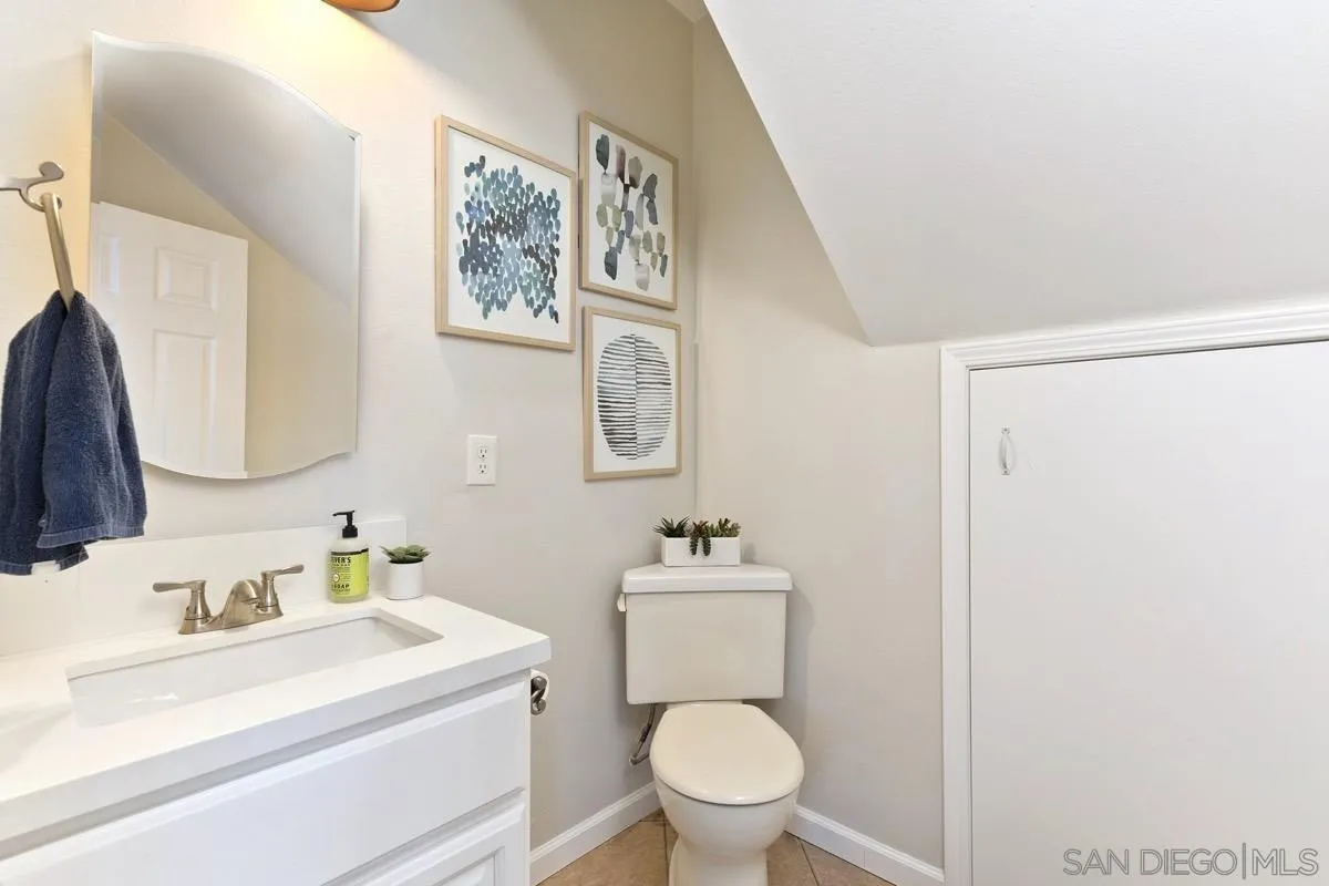 1448 Third Street Coronado, CA 92118 - Photo 20 of 30 a bathroom with a toilet sink vanity and mirror
