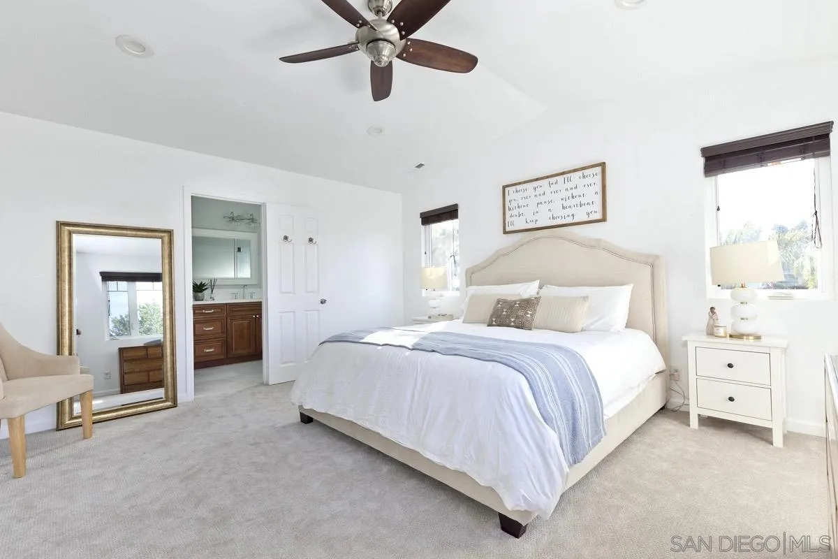 1448 Third Street Coronado, CA 92118 - Photo 23 of 30 a bedroom with a bed and a chandelier