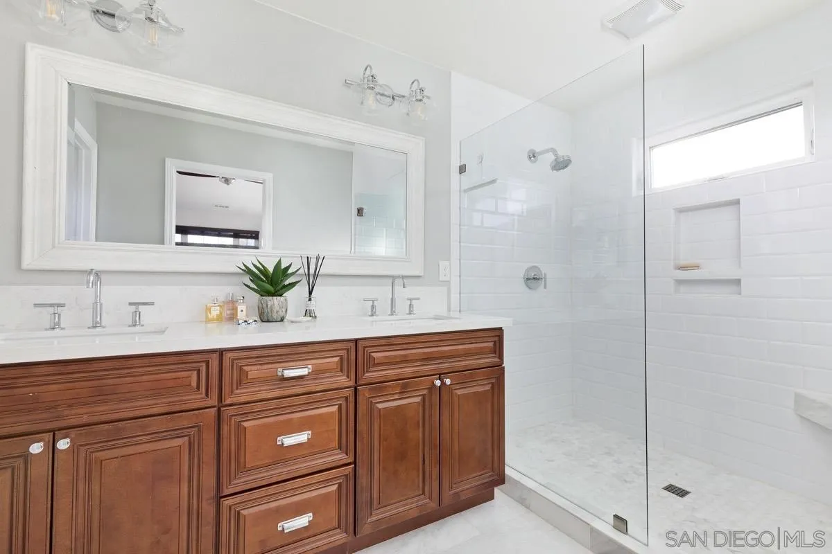 1448 Third Street Coronado, CA 92118 - Photo 26 of 30 a spacious bathroom with a granite countertop sink mirror and shower