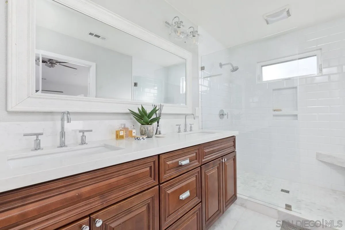 1448 Third Street Coronado, CA 92118 - Photo 27 of 30 a bathroom with a sink and a mirror