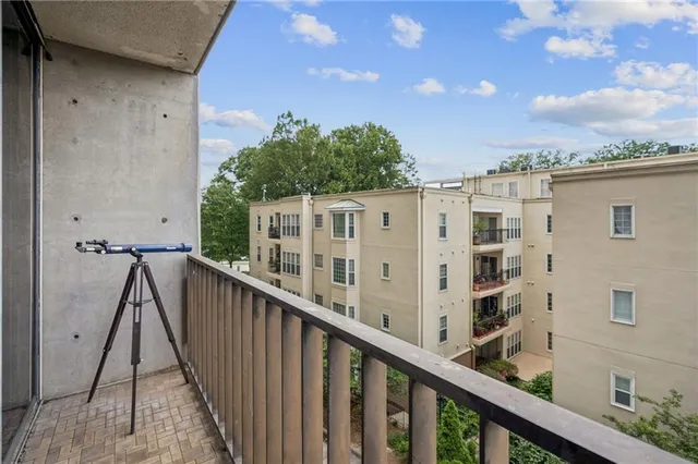 a view of a balcony with wooden fence and floor