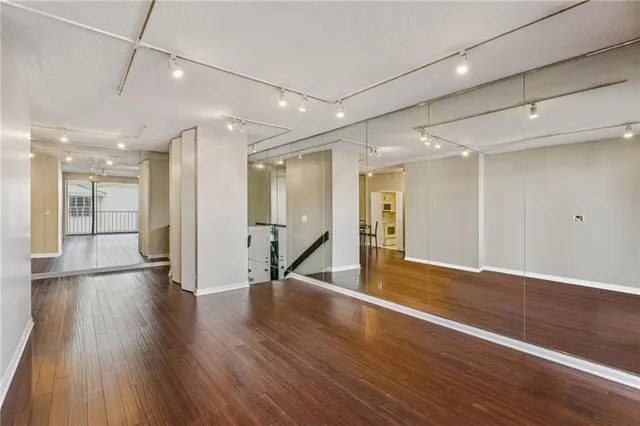 a view of a hallway with wooden floor