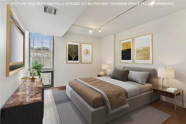 a bedroom with a large bed and a large window