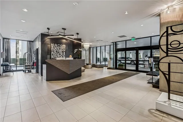 a lobby with furniture and a ceiling fan