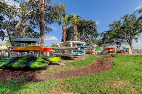 a view of a lake with table and chairs