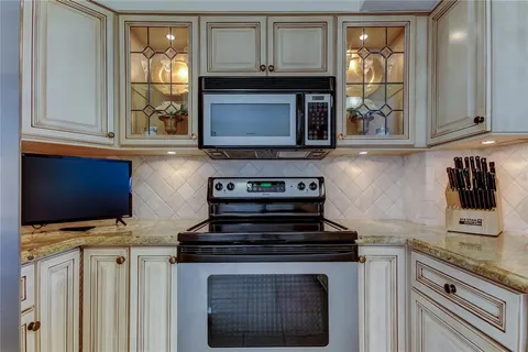 a stove top oven sitting inside of a kitchen