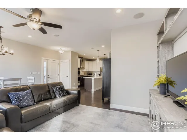 a living room with furniture and kitchen view