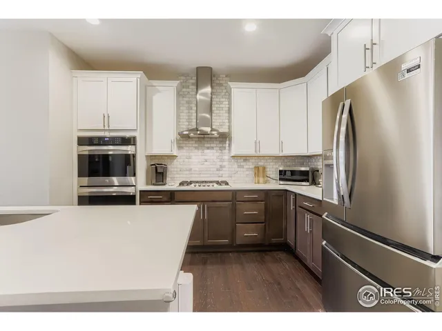 a kitchen with stainless steel appliances a refrigerator sink and microwave