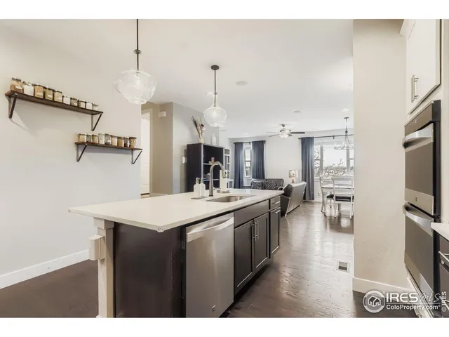 a kitchen with kitchen island a sink and a stove