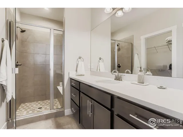 a bathroom with a sink a shower a mirror and a bathtub