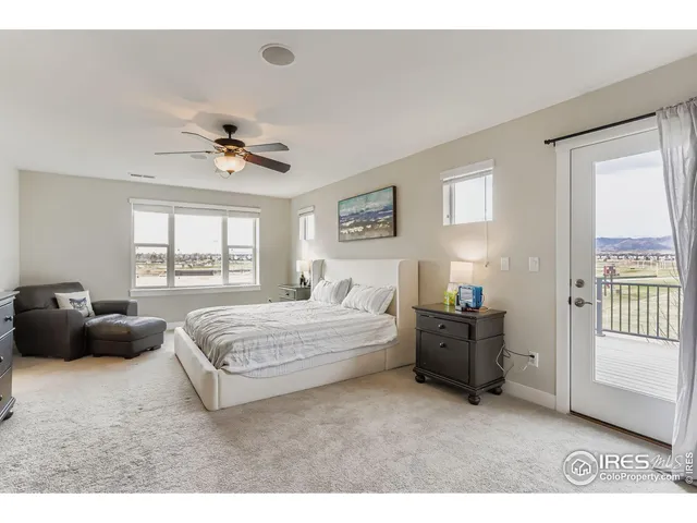 a spacious bedroom with a bed a couch and a window