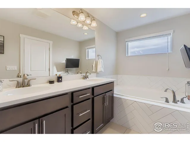 a bathroom with a sink a mirror and a vanity