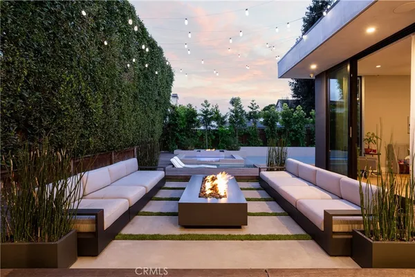 a outdoor sitting area with furniture and a potted plant