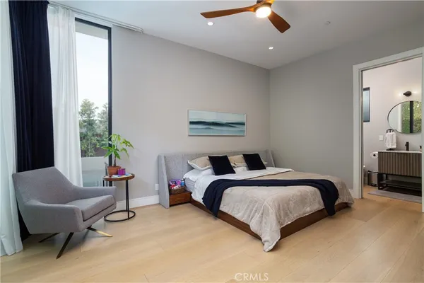 a spacious bedroom with a bed and a chandelier