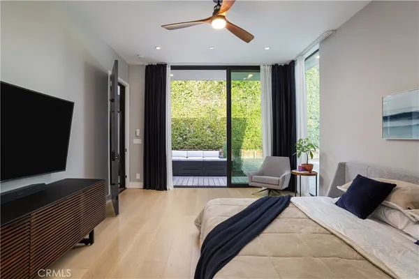 a bedroom with a bed and large window
