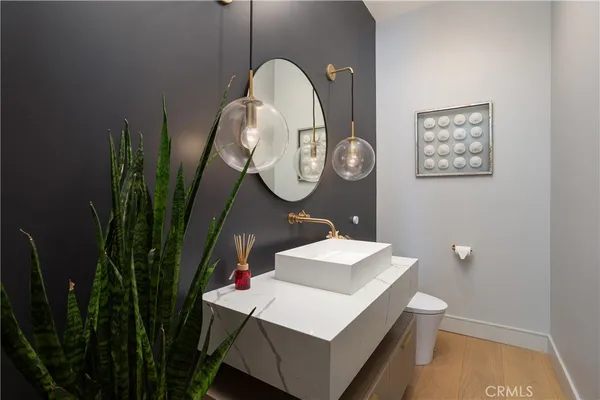 a bathroom with a sink mirror and vanity