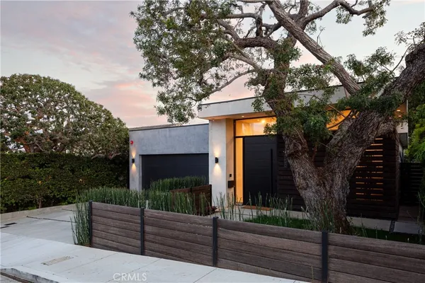 a front view of a house with tree tree
