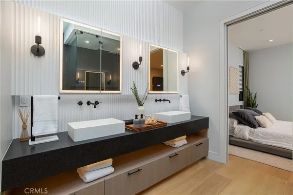 a bathroom with double vanity sinks and a mirror