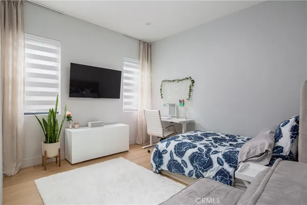 a bedroom with a bed and a flat screen tv