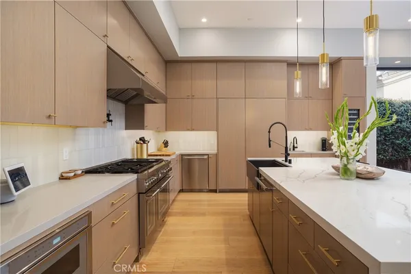 a kitchen with a sink a stove and cabinets