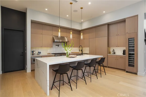 a kitchen with a table chairs refrigerator and microwave
