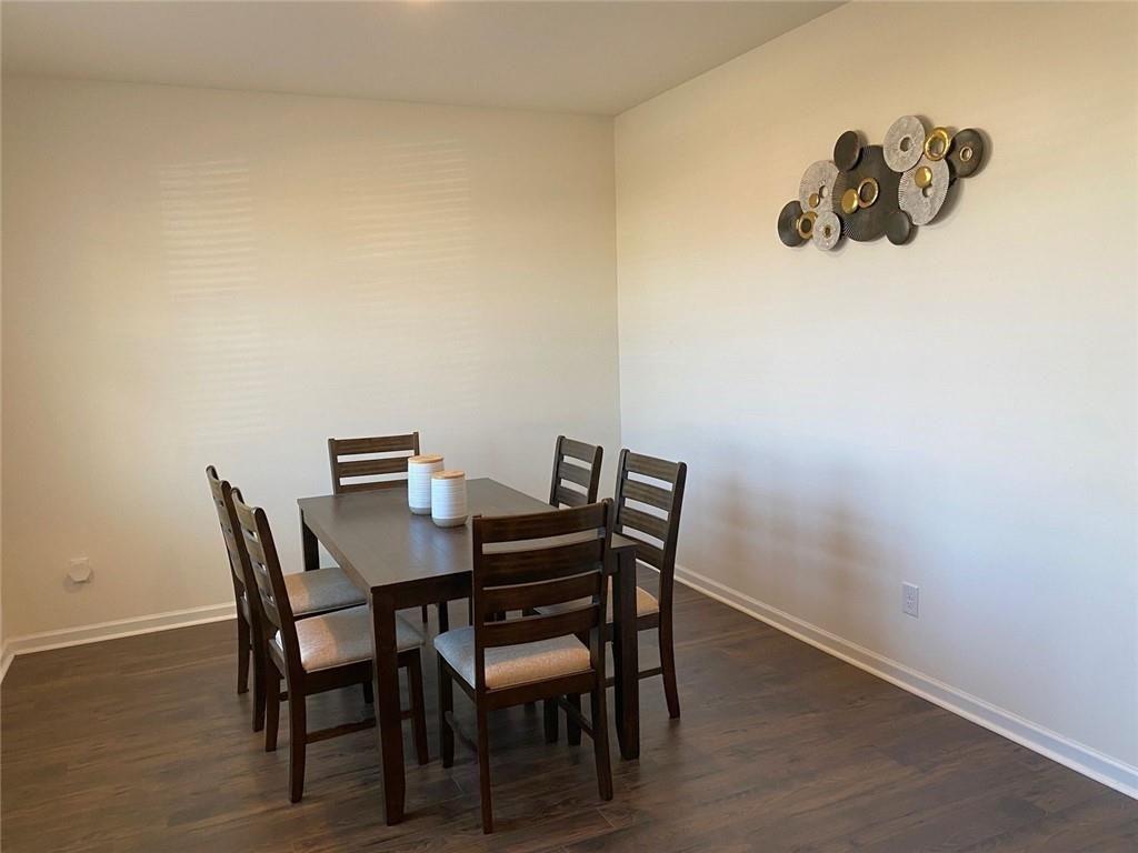 676 Whitman Lane Stockbridge, GA 30281 - Photo 13 of 50 a view of a dining room with furniture and wooden floor