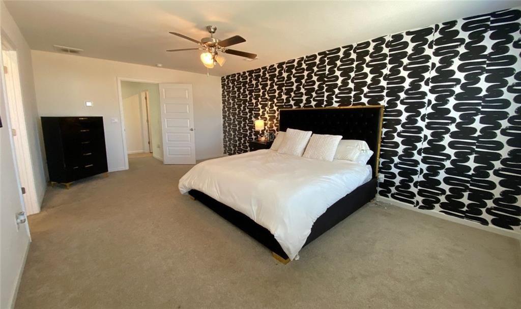 676 Whitman Lane Stockbridge, GA 30281 - Photo 15 of 50 a bedroom with a bed and a walk in closet