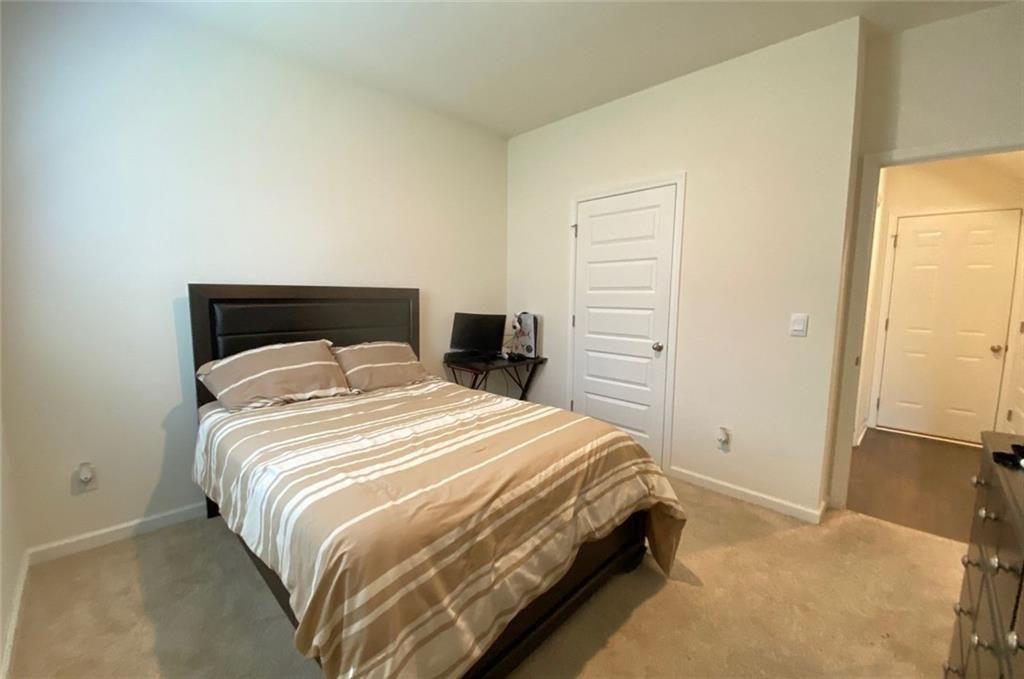 676 Whitman Lane Stockbridge, GA 30281 - Photo 18 of 50 a bedroom with a bed and closet