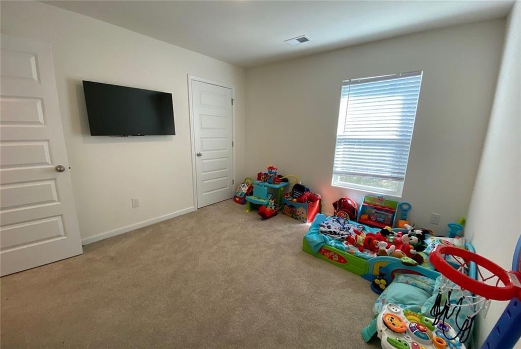 676 Whitman Lane Stockbridge, GA 30281 - Photo 21 of 50 a children room with toys and a flat screen tv