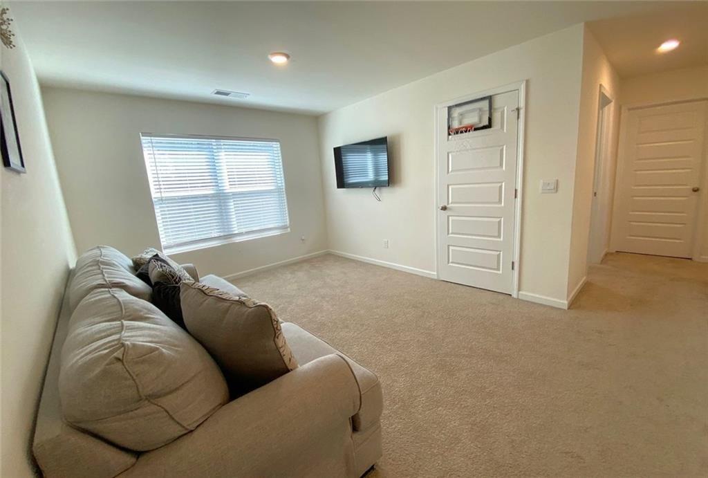 676 Whitman Lane Stockbridge, GA 30281 - Photo 27 of 50 a living room with furniture and a window