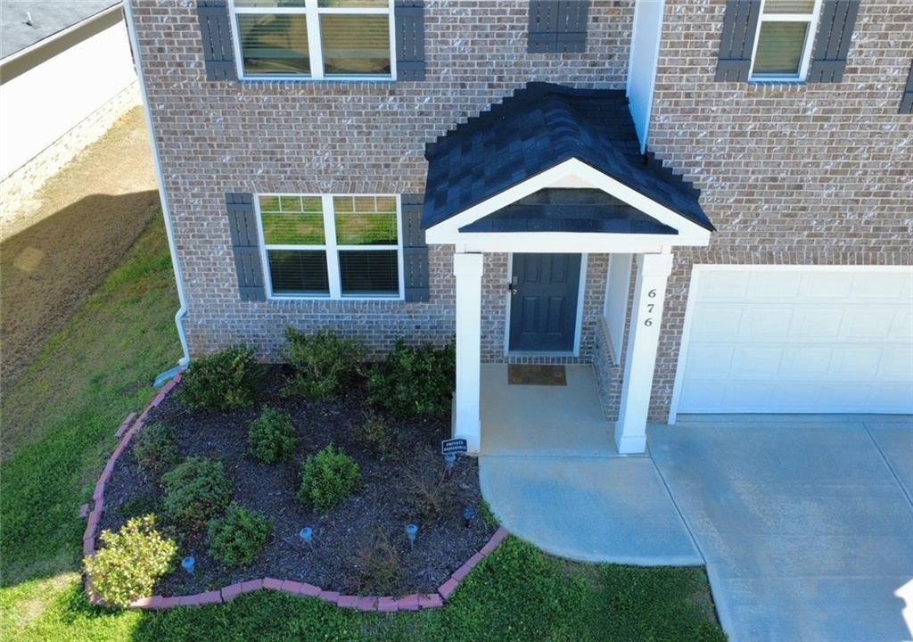 676 Whitman Lane Stockbridge, GA 30281 - Photo 3 of 50 a view of a house with brick walls and a yard