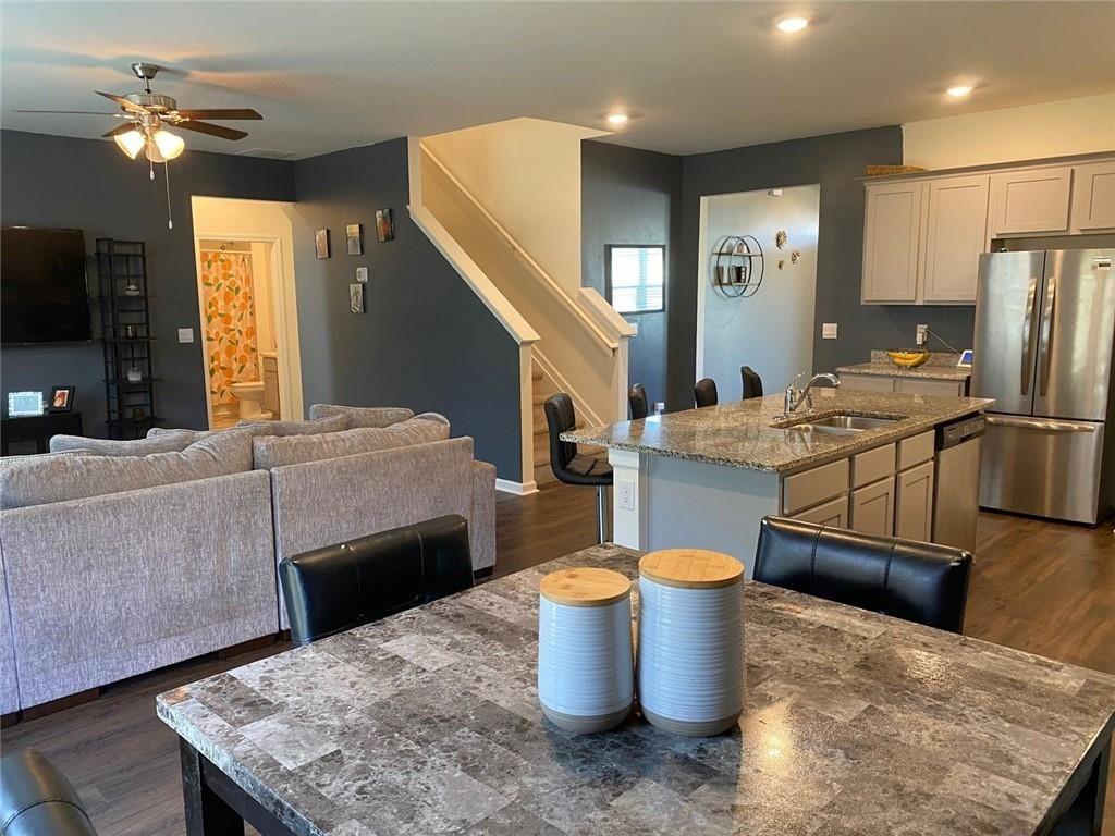 676 Whitman Lane Stockbridge, GA 30281 - Photo 8 of 50 a living room with furniture a flat screen tv and kitchen view