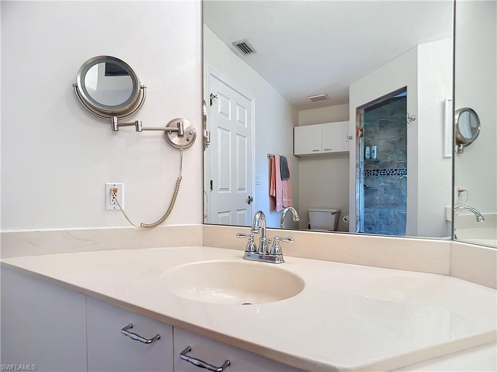 2860 Citrus Lake Drive, Unit R202 Naples, FL 34109 - Photo 38 of 50 a bathroom with a sink and a mirror