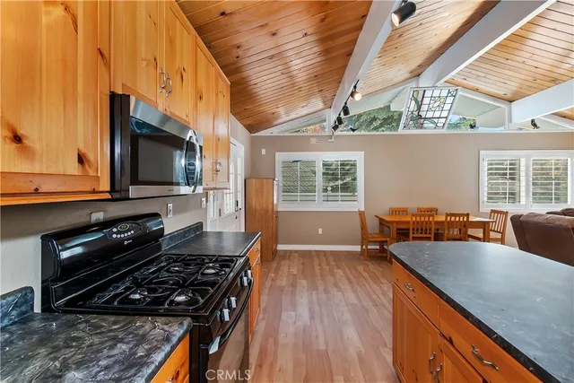 a kitchen with a stove a sink and a microwave