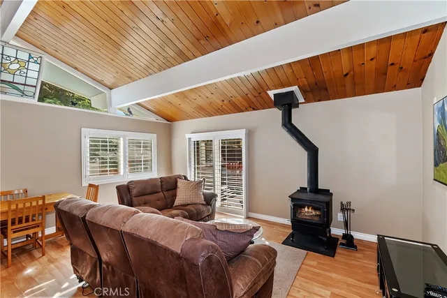 a living room with furniture a flat screen tv and windows
