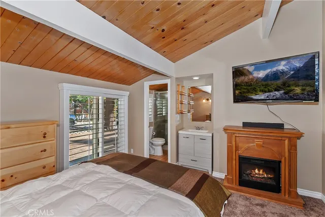 a bedroom with a bed and a fireplace