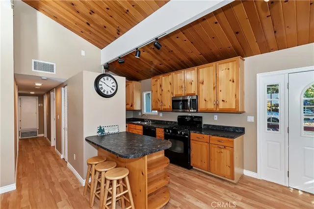 a kitchen with a stove a refrigerator and a sink