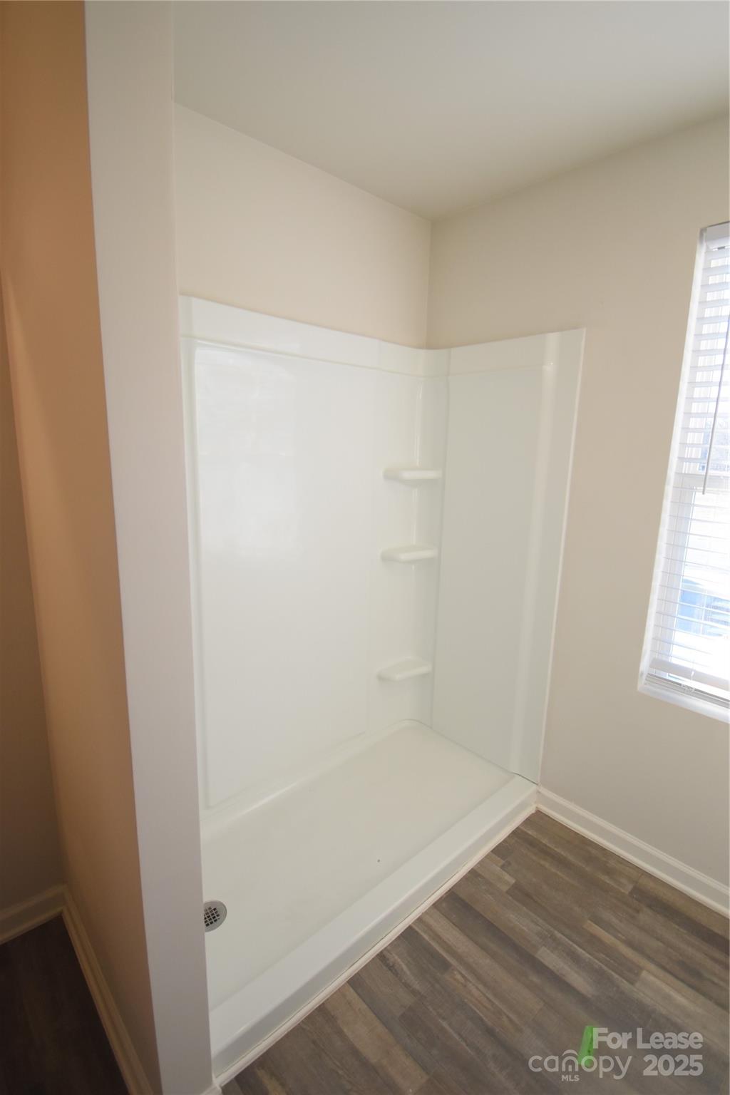 569 Calvin Sowers Road Lexington, NC 27295 - Photo 11 of 20 an empty room with wooden floor and windows