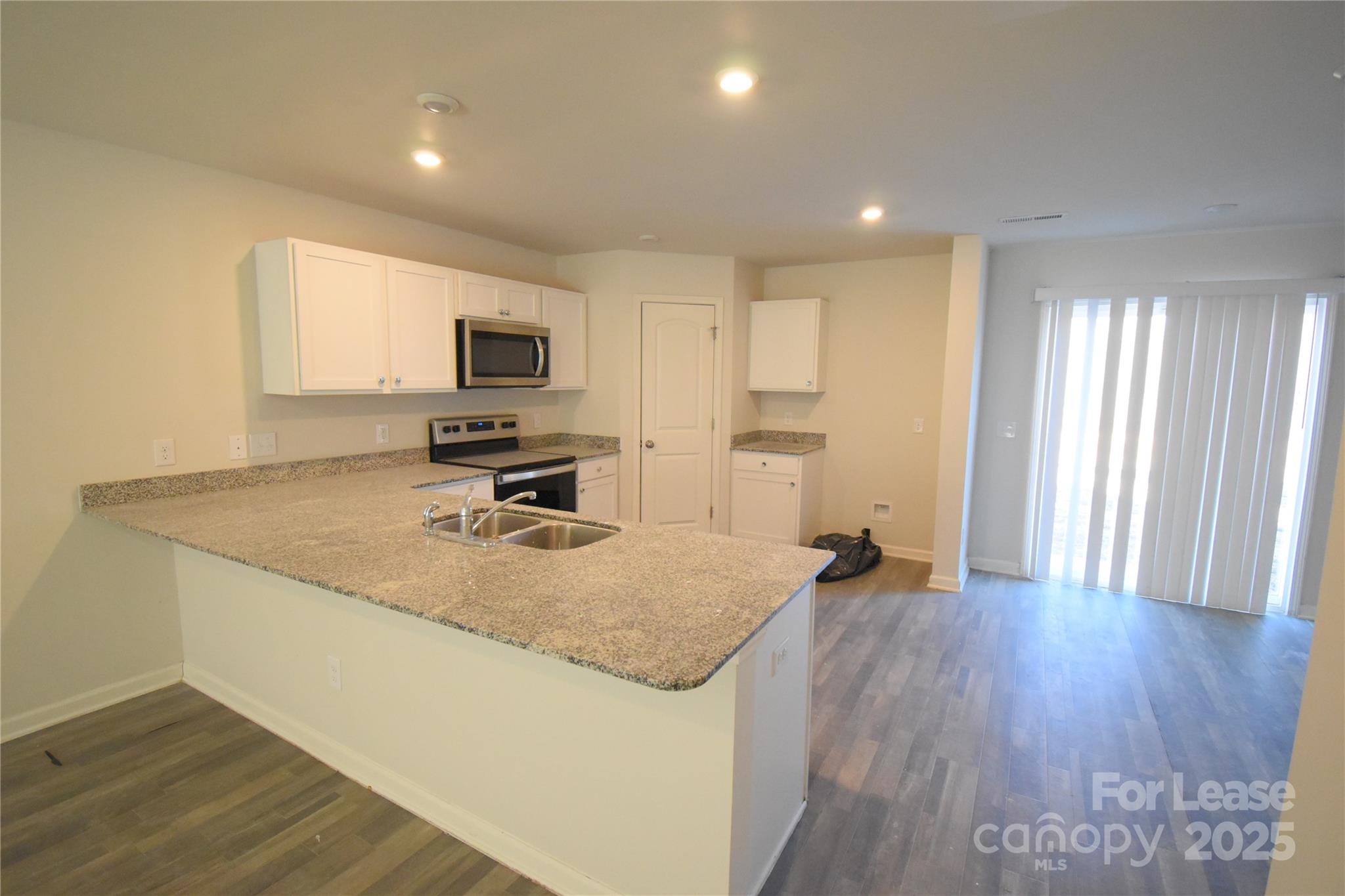 569 Calvin Sowers Road Lexington, NC 27295 - Photo 5 of 20 a view of a kitchen with a sink dishwasher microwave oven and cabinets