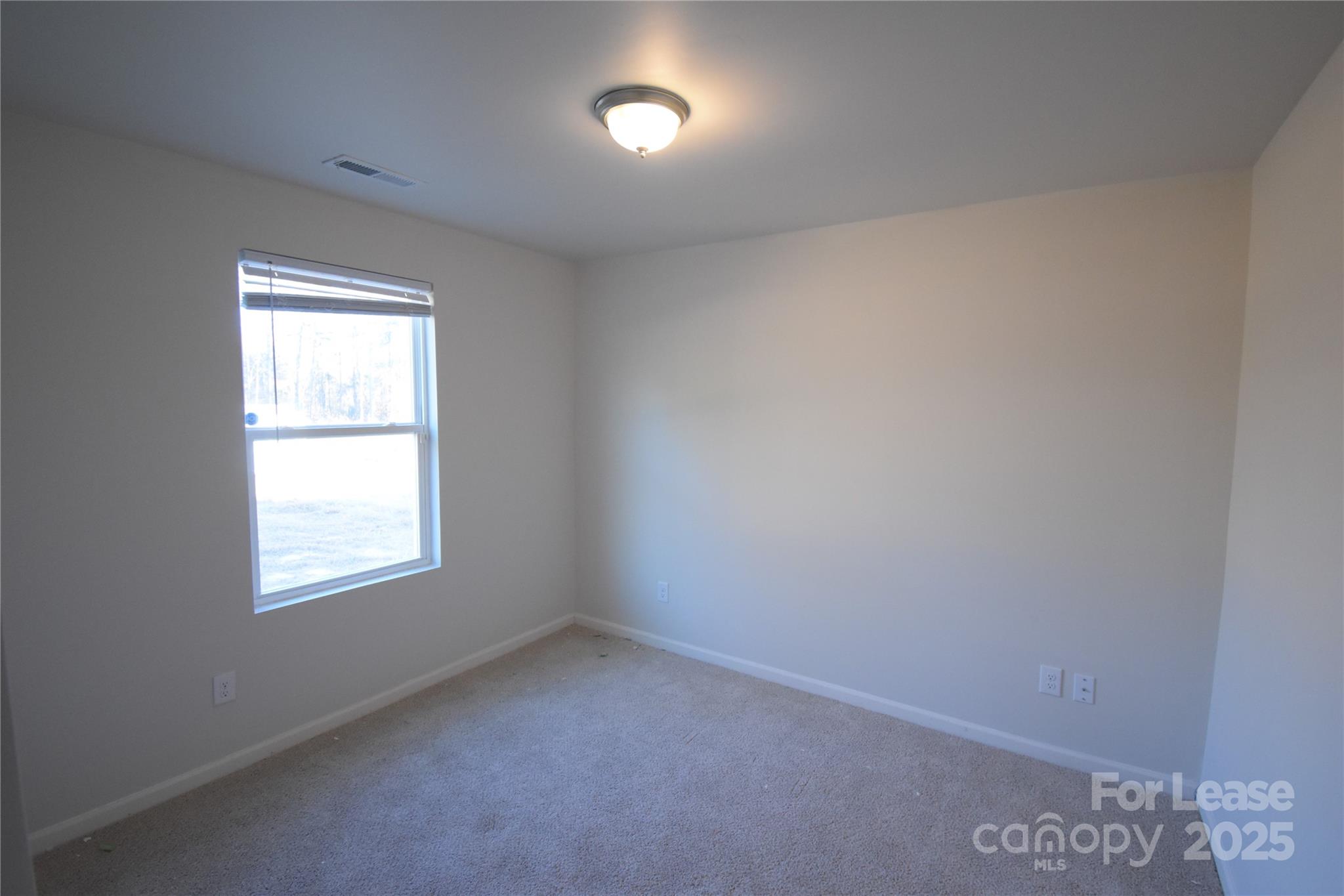 569 Calvin Sowers Road Lexington, NC 27295 - Photo 9 of 20 an empty room with a window