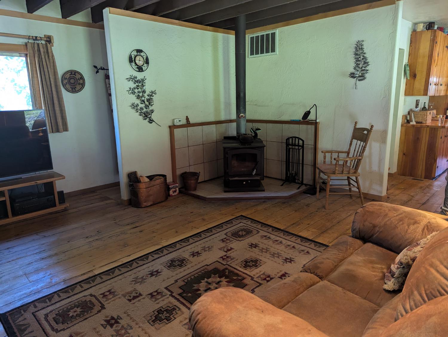 6105 Little Mountain Road Somerset, CA 95684 - Photo 5 of 21 living area featuring hardwood / wood-style flooring and a wood stove