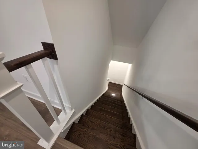 a large kitchen with stainless steel appliances kitchen island a large counter top a stove and a chandelier