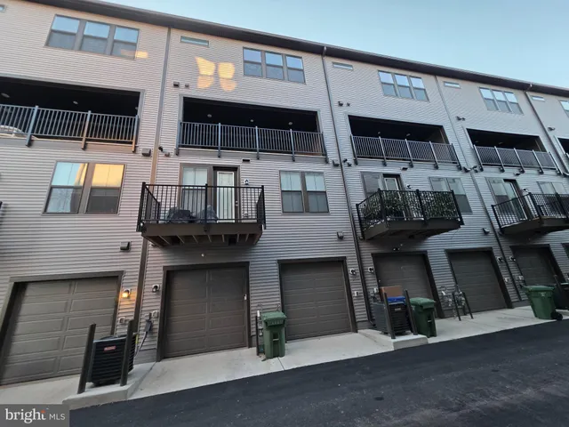 a view of a blue building with wooden fence