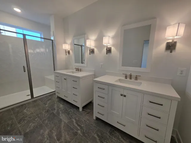 a bathroom with a sink and mirror with toilet
