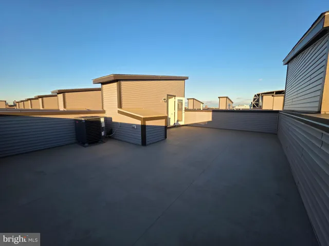 a view of a building with wooden fence