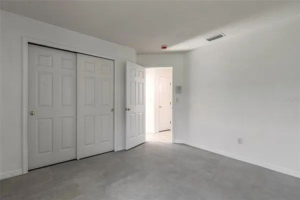 a bathroom with a granite countertop sink a toilet a mirror and shower