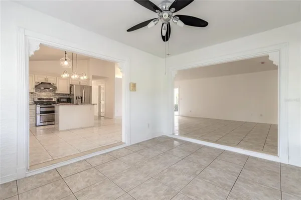 a kitchen with kitchen island granite countertop a sink a stove and cabinets