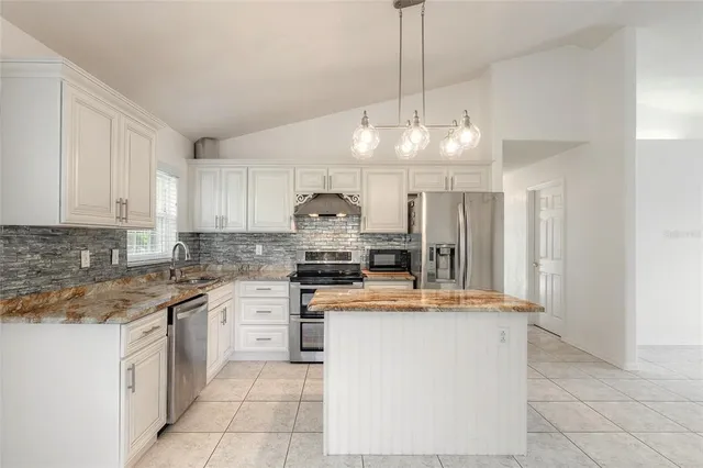 a view of an empty room with windows and city view