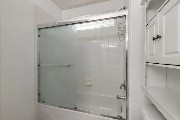 an empty room with chandelier fan